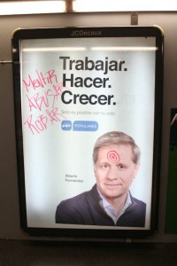 The words mentir, abusar, and robar (lie, abuse, steal) cover a political advertisement for the Popular Party. The defaced advertisement hangs in the Clot Metro stop in Barcelona. The advertisement is for Alberto Fernández who is currently a councilor and chairman of the Popular Party. Photo by Clara Cutbill